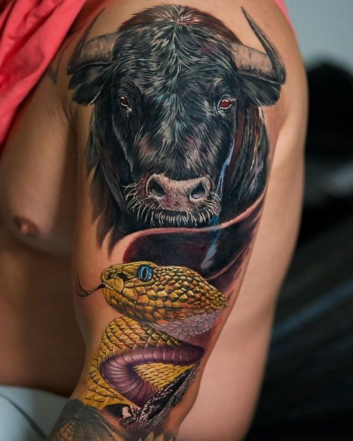 Realistic bull and snake tattoo design for men on arm and bicep tattoo ideas