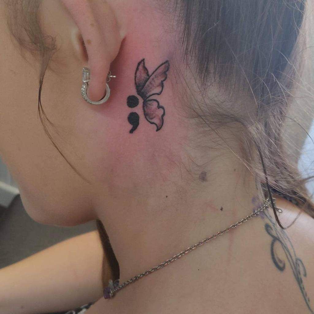 Minimalist semicolon and butterfly tattoo design for women behind the ear tattoo ideas