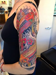 Japanese koi fish and flower tattoo design for women on half sleeve tattoo ideas