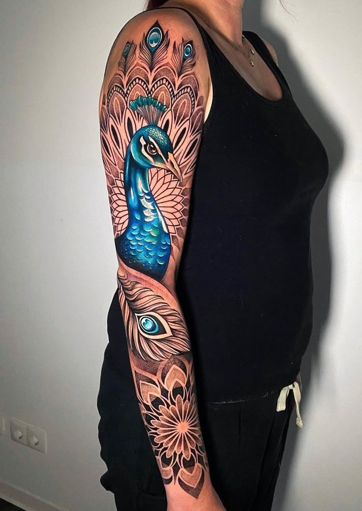 Realistic peacock and feather tattoo design for women on arm tattoo ideas