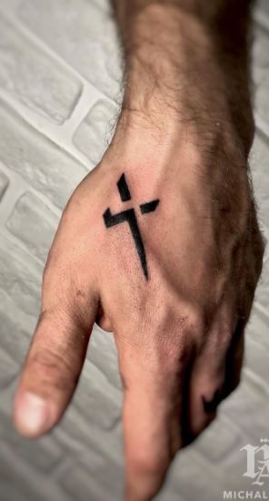 Blackwork cross tattoo design for men on hand tattoo ideas