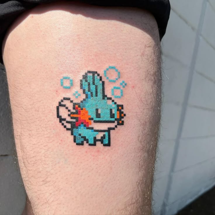 Pixel art Mudkip tattoo design for men on thigh tattoo ideas