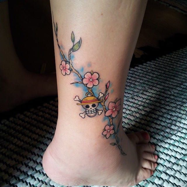 Anime cherry blossoms and skull tattoo design for women on ankle tattoo ideas