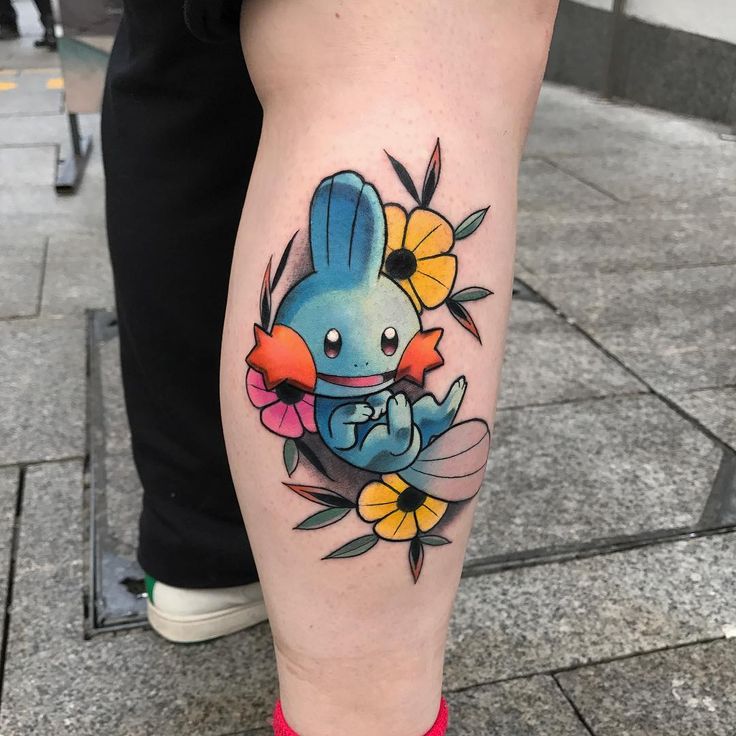 Cute Mudkip and flower tattoo design for women on leg tattoo ideas