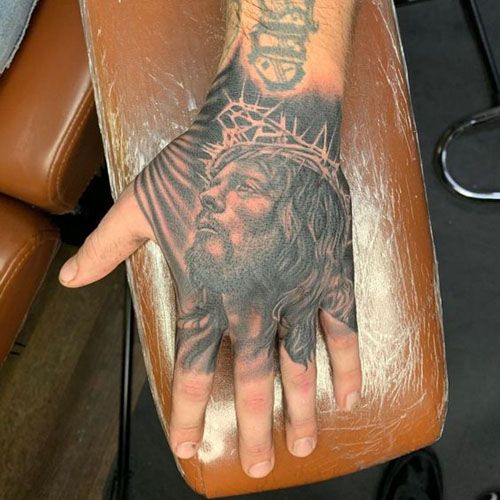 Realistic Jesus religious tattoo design for men on hand tattoo ideas