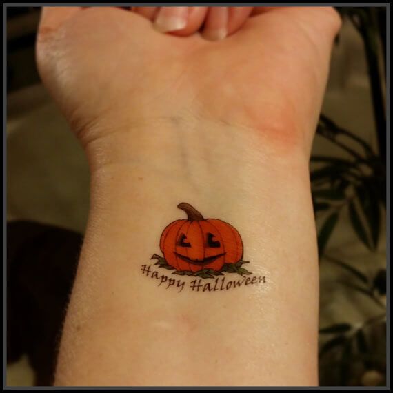 Halloween pumpkin tattoo design for women on wrist tattoo ideas