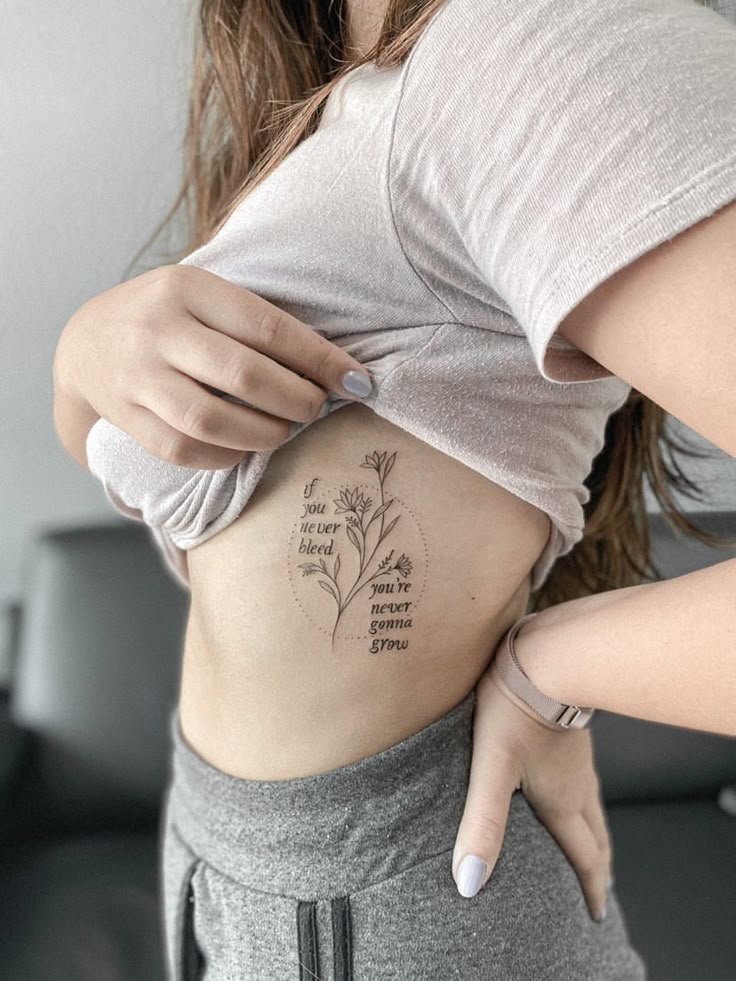 Fine line floral and quote tattoo design for women on rib tattoo ideas