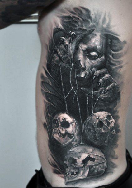 Dark realism puppet master with skulls tattoo design for men on rib tattoo ideas