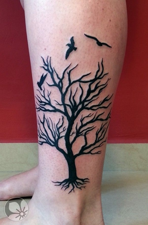Blackwork tree and bird tattoo design for women on leg tattoo ideas