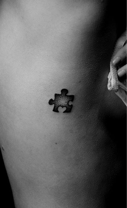 Dotwork puzzle piece with heart tattoo design for women on rib tattoo ideas