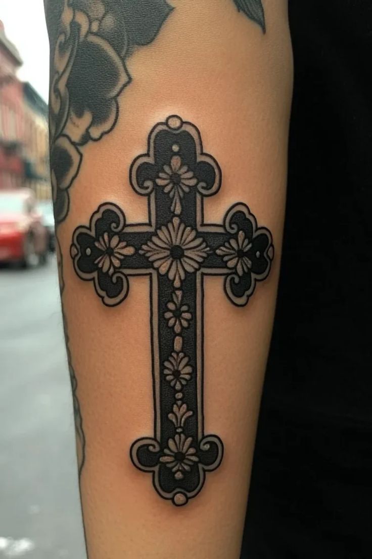 Blackwork cross and floral tattoo design for women on arm tattoo ideas