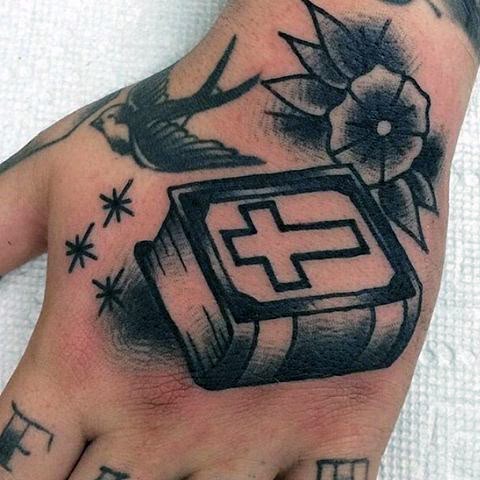 Traditional cross and Norse symbol tattoo design for men on hand with flower tattoo ideas