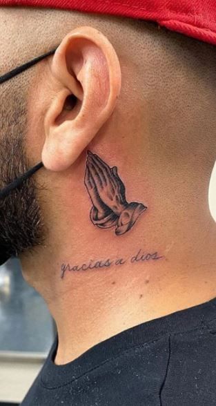 Realistic praying hands and quote tattoo design for men on neck tattoo ideas