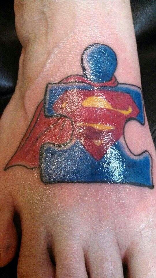 Traditional autism puzzle piece with Superman symbol and cape tattoo idea for guys and ladies on hand tattoo ideas