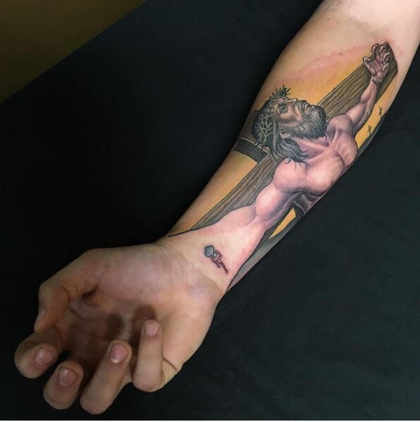 Jesus Christ crucifixion tattoo design for men on forearm and wrist tattoo ideas