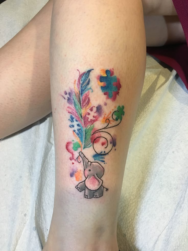 Watercolor autism and feather tattoo design for women on leg tattoo ideas