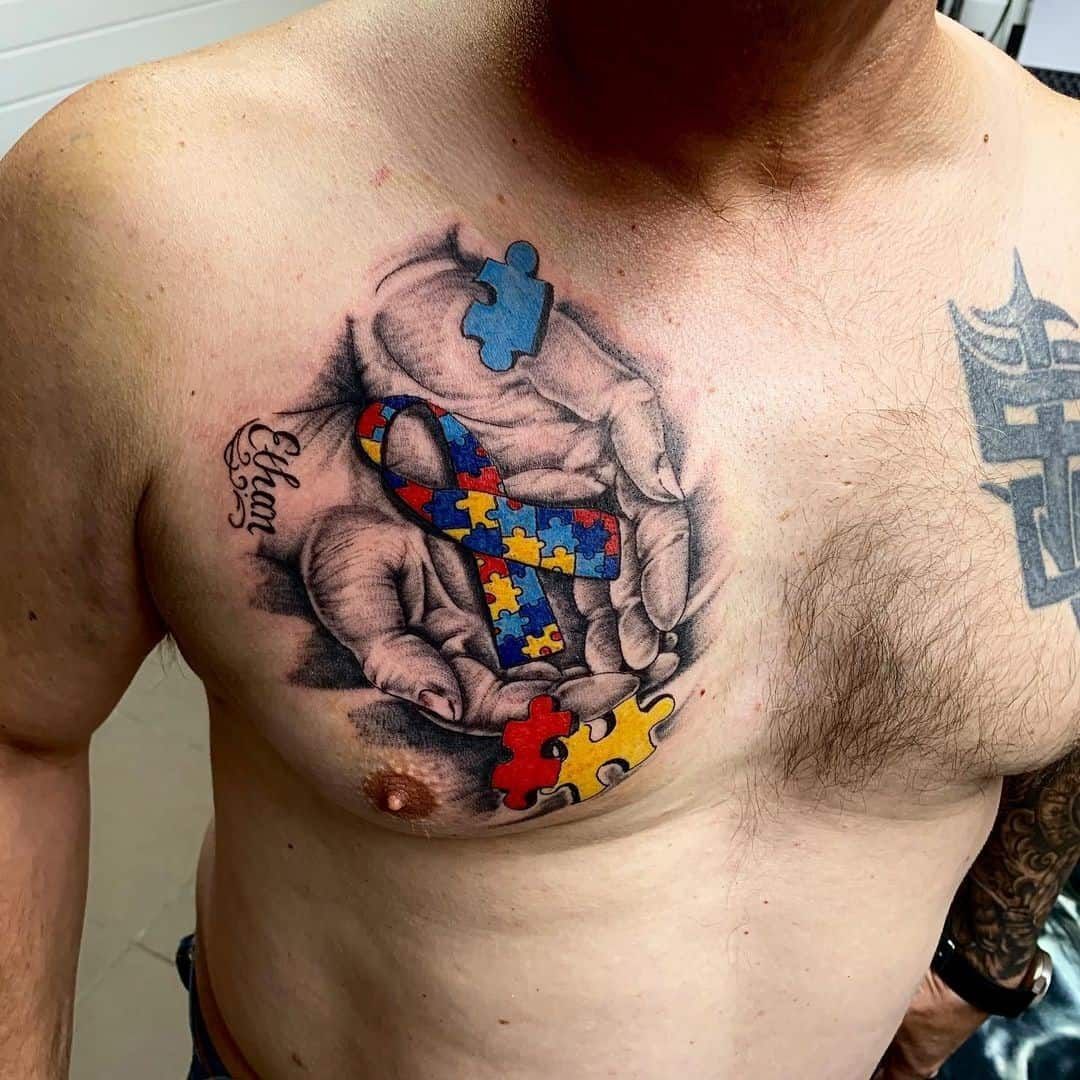 Realistic autism awareness ribbon and puzzle pieces tattoo design for men on chest tattoo ideas