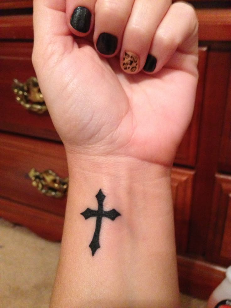 Blackwork cross tattoo design for women on wrist tattoo ideas