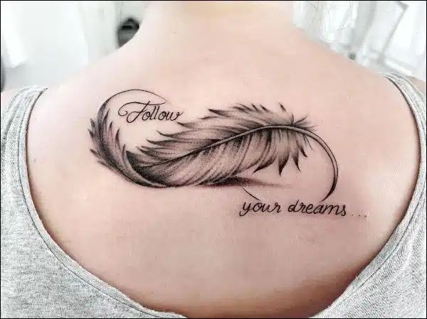 Fine line feather and quote tattoo design for women on back tattoo ideas