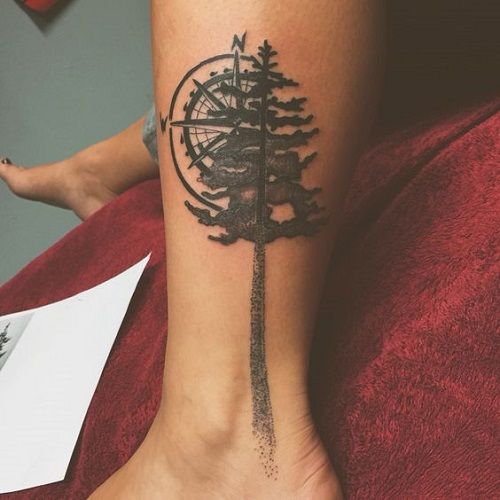 Blackwork compass and tree tattoo design for women on leg tattoo ideas
