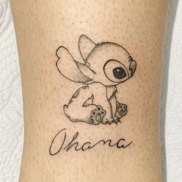 Black and grey Stitch tattoo design for women with Ohana text on leg tattoo ideas