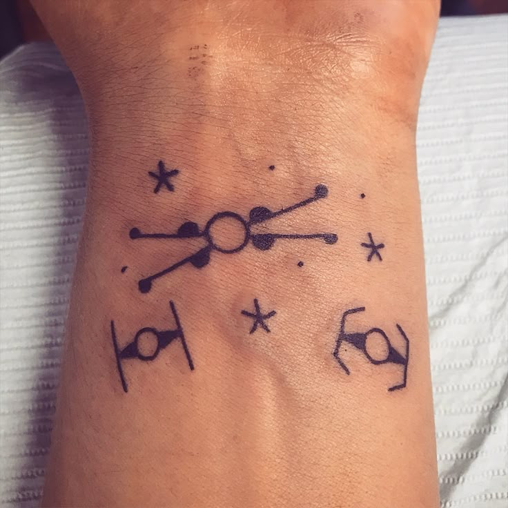 Minimalist Star Wars spaceship tattoo design for men on wrist tattoo ideas