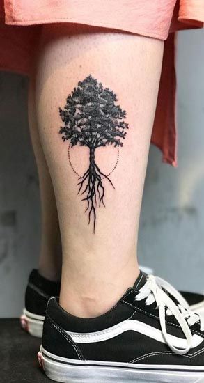 Blackwork tree tattoo design for women on leg tattoo ideas