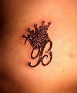Black and grey crown and initial tattoo design for women on back tattoo ideas