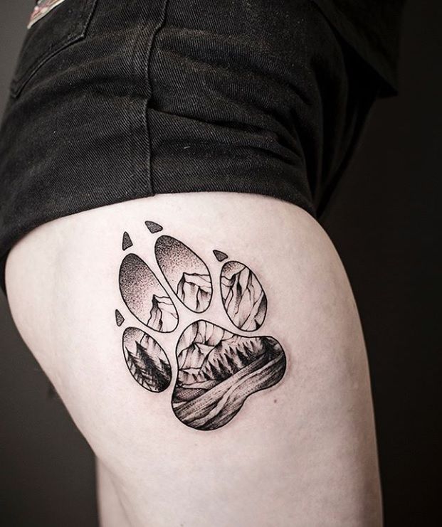 Blackwork mountain and wolf paw tattoo design for women on thigh tattoo ideas
