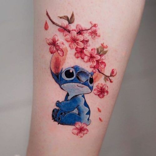 Cute anime Stitch and floral tattoo design for women on leg tattoo ideas