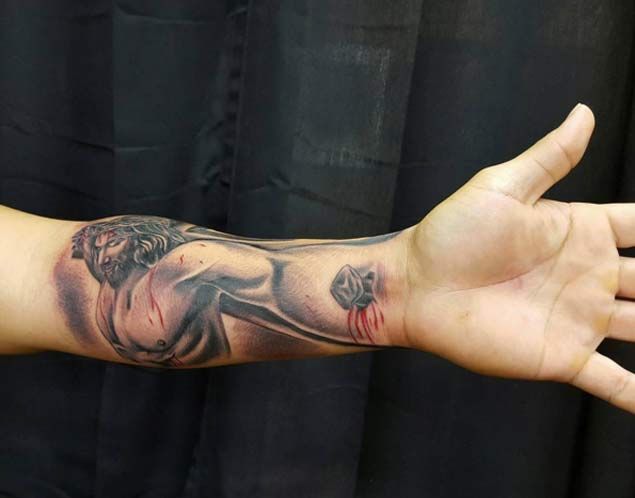 Realistic Jesus and cross tattoo design for men on forearm and wrist tattoo ideas