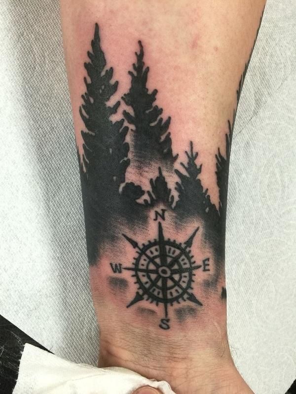 Blackwork forest and compass tattoo design for men on forearm tattoo ideas