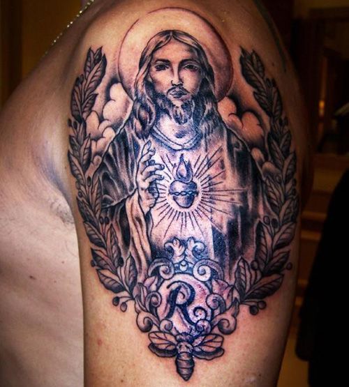 Realistic Jesus tattoo design for men on shoulder with bee and floral elements tattoo ideas