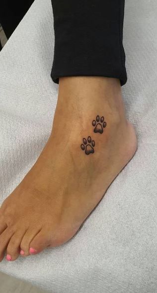 Minimalist paw print tattoo design for women on ankle tattoo ideas
