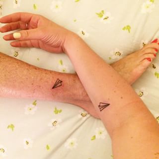 Minimalist paper airplane tattoo design for women and men on forearm and ankle tattoo ideas