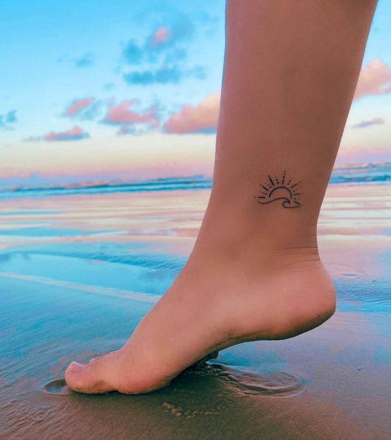 Linework sun and ocean tattoo design for women on her ankle tattoo ideas