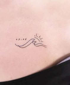Minimalist sun and ocean wave tattoo design for women on rib tattoo ideas
