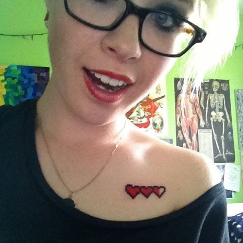 Pixelated heart video game tattoo design for women on chest tattoo ideas
