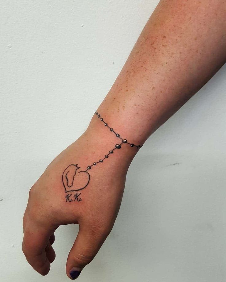 Fine line horse and heart tattoo design with initials for women on hand and wrist tattoo ideas