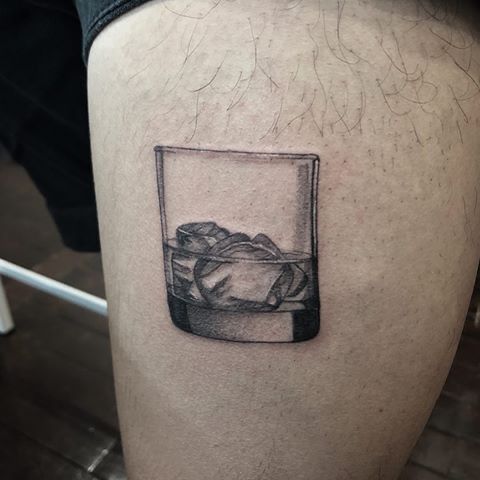 Realistic glass of whiskey tattoo design for men on thigh tattoo ideas