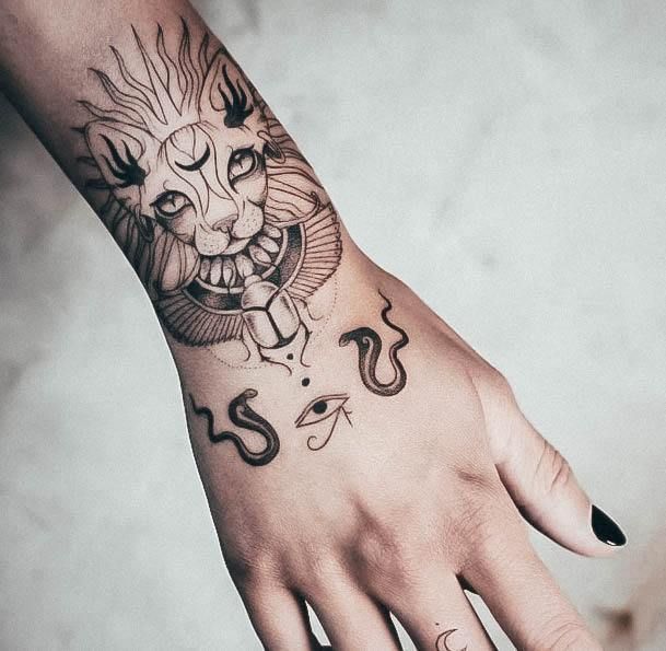 Fine line scorpion, eye, and snake tattoo design for women on forearm and hand tattoo ideas
