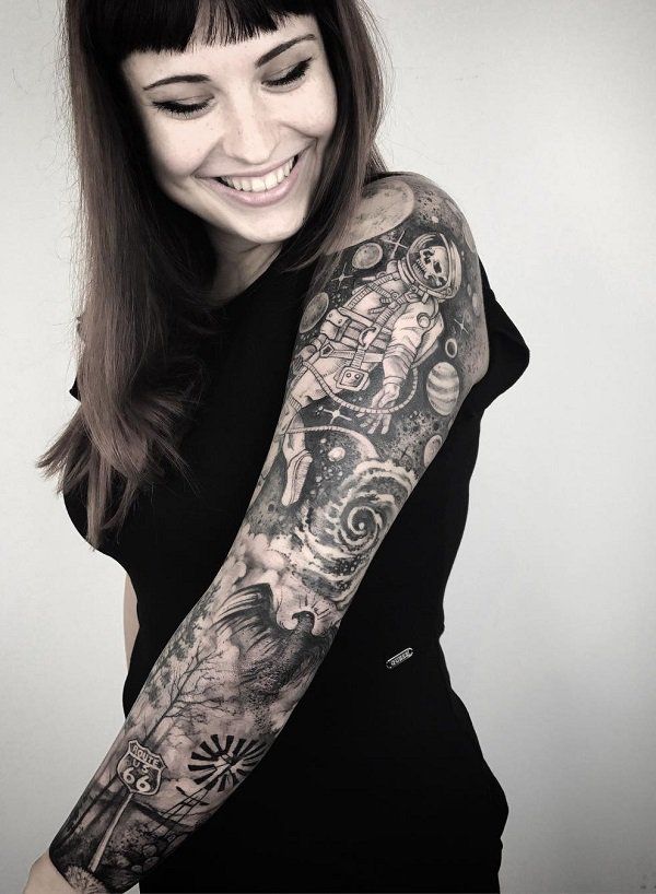 Realistic astronaut and phoenix tattoo design for women on full sleeve arm with space and Route 66 elements tattoo ideas