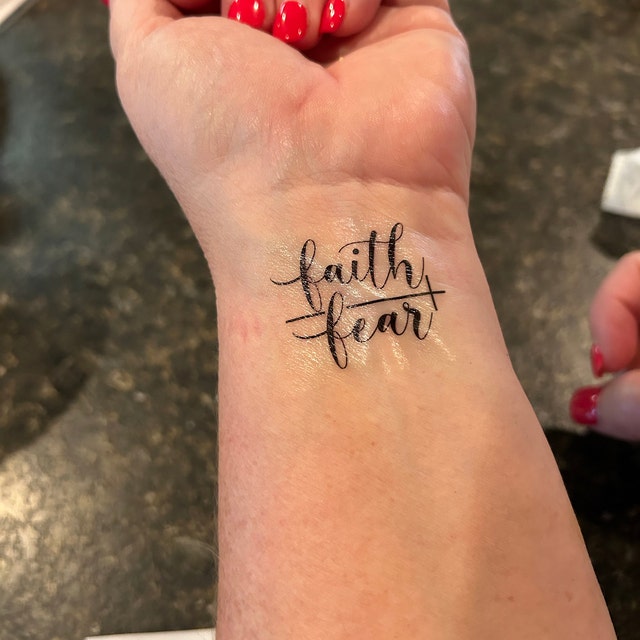Script faith over fear quote tattoo design for women on wrist tattoo ideas