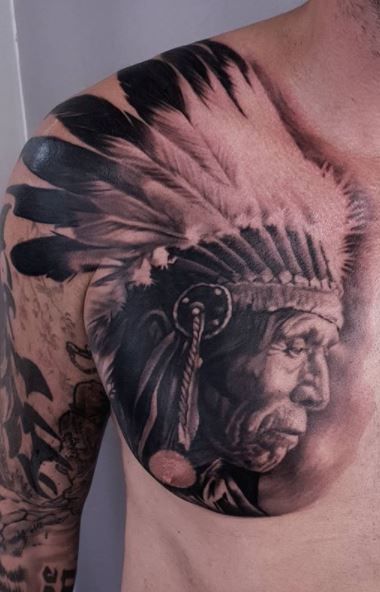 Realistic portrait of a Native American man with feathers tattoo design for men on chest and arm tattoo ideas