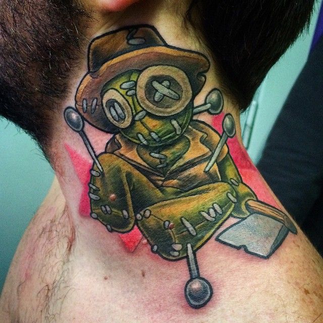 Creepy doll tattoo design for men and women with axe on neck tattoo ideas