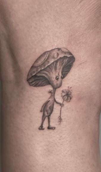Sketchy mushroom creature with flower tattoo design for men and women on rib tattoo ideas