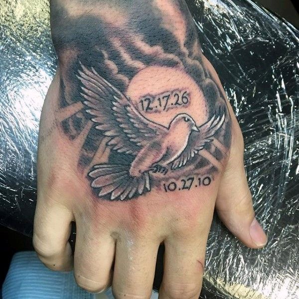 Black and grey dove and date of birth tattoo design for men on hand tattoo ideas