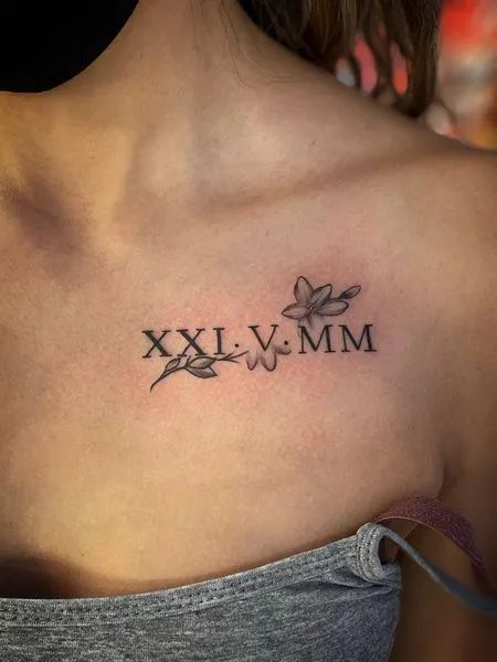 Fine Line Roman numeral and floral tattoo design for women on chest tattoo ideas