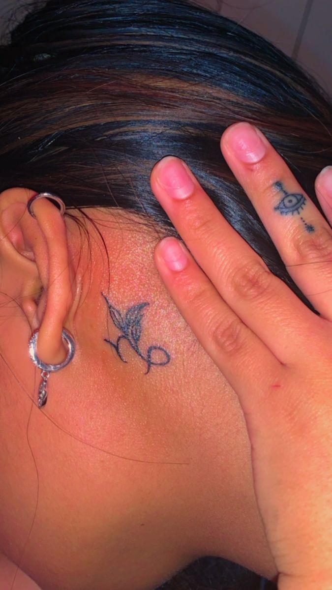 Fine line Capricorn tattoo design for women on neck tattoo ideas