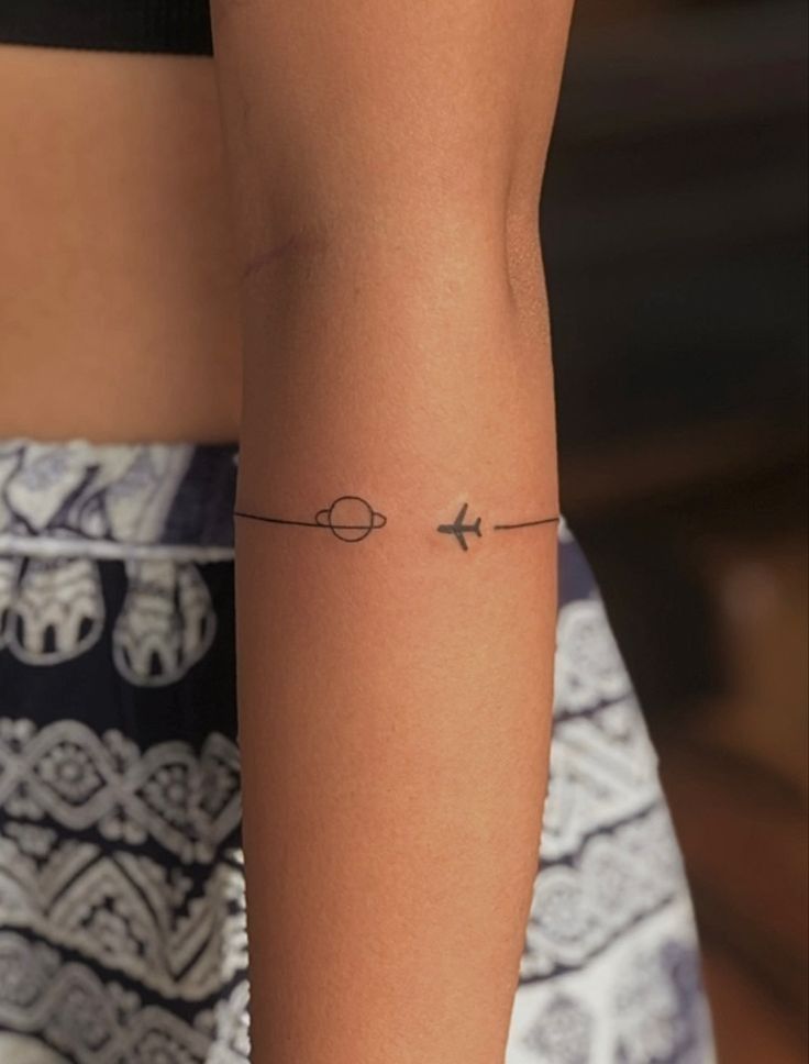Minimalist airplane and planet tattoo design for women tattoo ideas